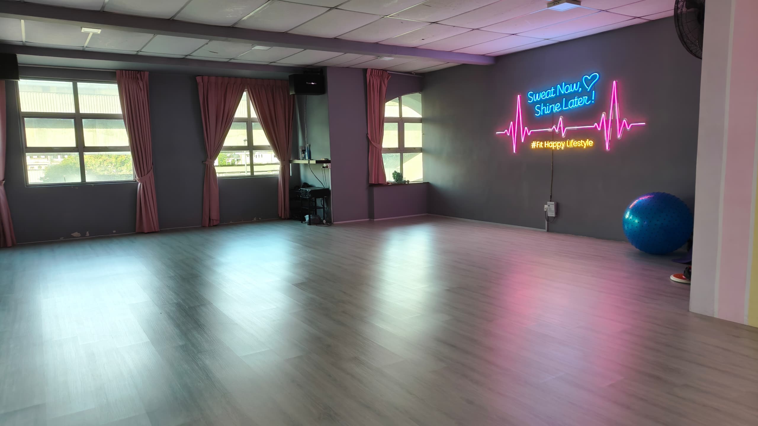 Meet In Studio evening atmosphere — Sweat Now Shine Later neon sign, pink curtains, dance fitness studio KL
